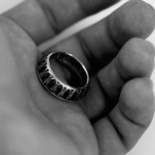 Side profile showing continuous relief motifs on sterling silver (925) band