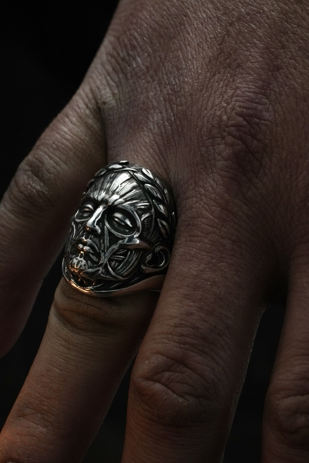 Anatomy of Power sculptural silver ring worn on hand for scale