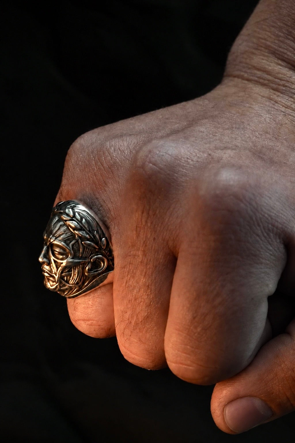 Anatomy of Power ring worn on a closed hand showing its side profile